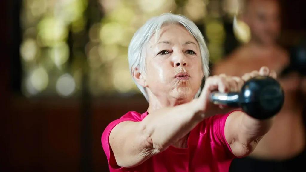 Toning Arms Without the Bulk: Is It Achievable? 1 Woman doing resistance band exercises for toned arms Cirencester