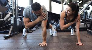 Image of man and woman doing Cardio Cirencester to tone their arms. 